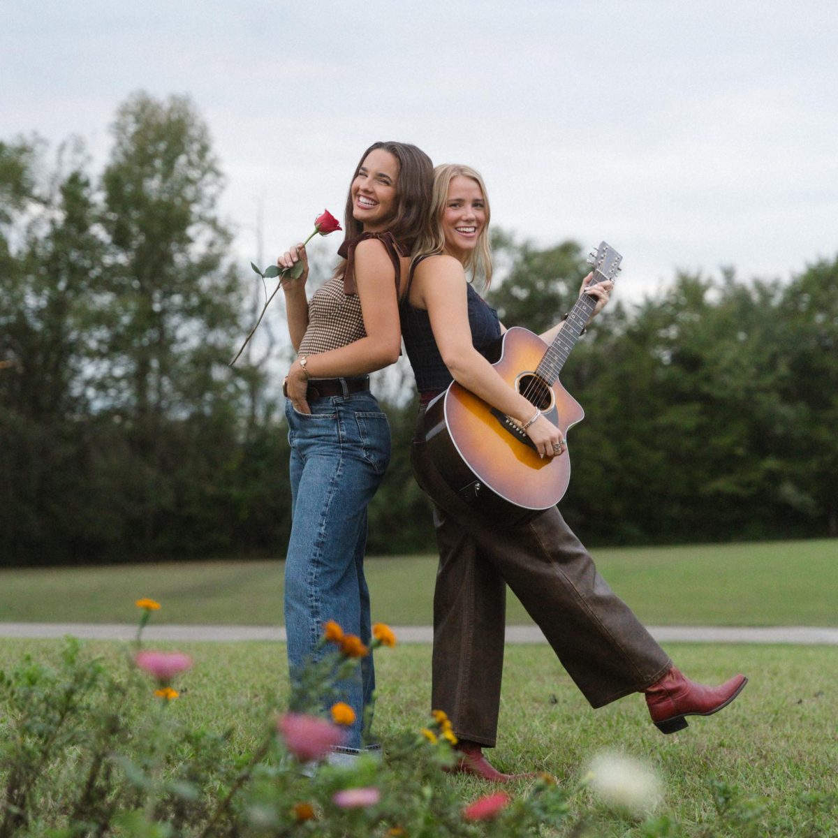 Jenna Raine and Avery Anna smile back to back. (Courtesy of Megan Edgemond/Warner Records)