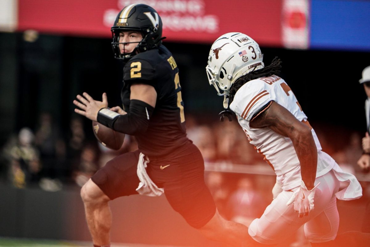 Diego Pavia scrambles while faced by Jaylon Guilbeau. (Hustler Multimedia/Michael Tung)