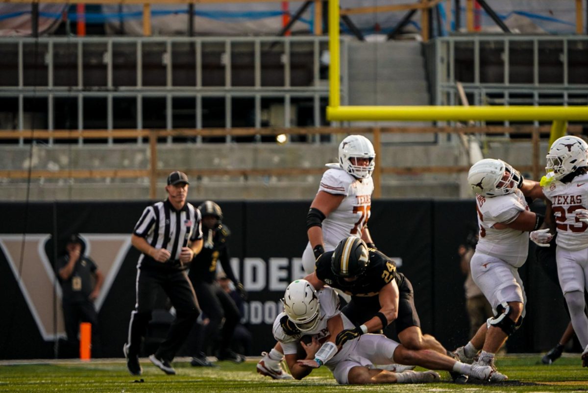 Nick Rinaldi gets a sack on Texas quarterback Quinn Ewers. (Hustler Multimedia/Michael Tung)