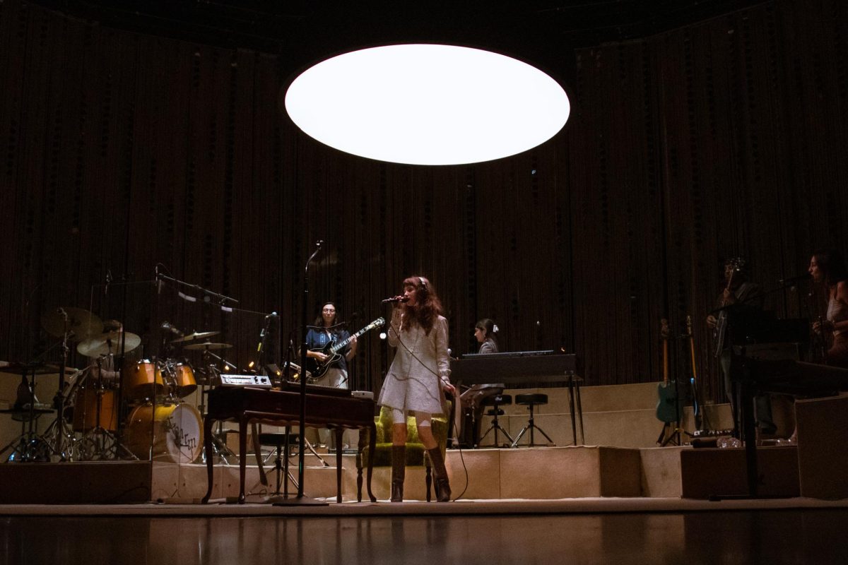 Clairo dances under the light with her band, as photographed on Nov. 4, 2024. (Hustler Multimedia/Savannah Walske)