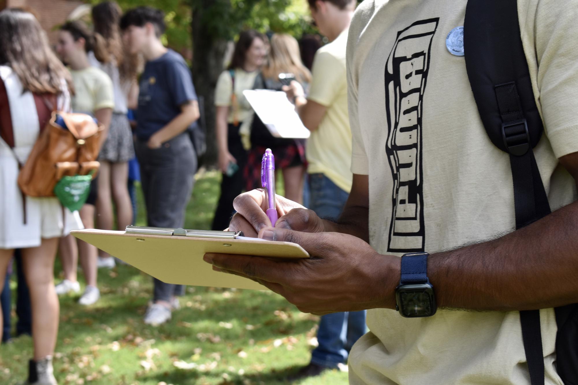 Student holds pen and clipboard at a Vanderbilt Graduate Workers United rally, as photographed on Sept. 9, 2022. (Hustler Multimedia/Amelia Simpson)  