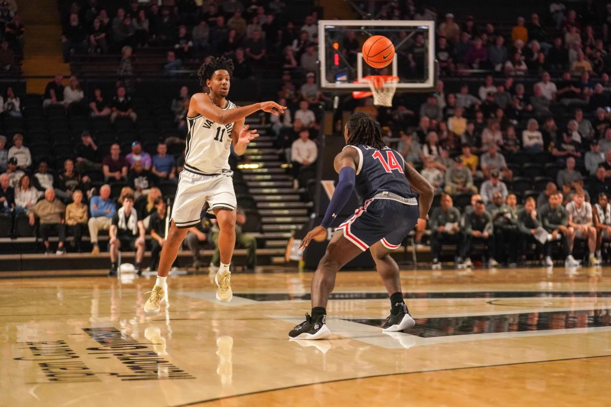 AJ Hoggard passes the ball over a Jackson State defender, as photographed on Nov. 16, 2024. (Hustler Multimedia/Connor Campbell)