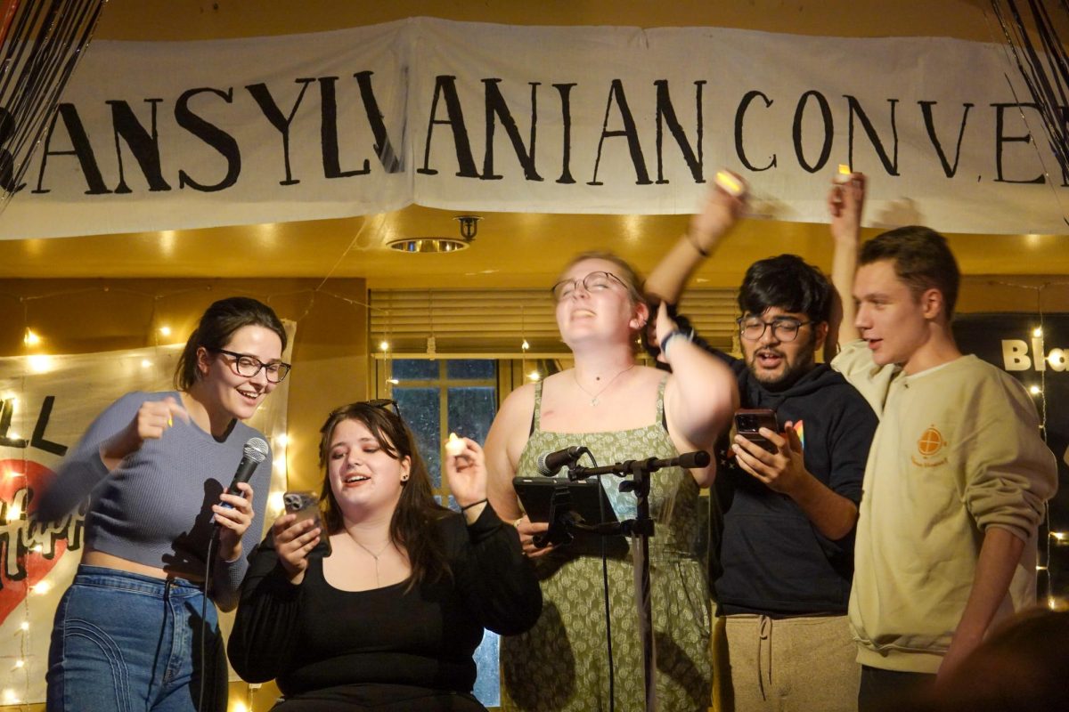 Senior McGill organizers perform the Munchie Mart song at the McGill Coffeehouse, as photographed on Oct. 18, 2024. (Hustler Multimedia/Alex Brodeur)