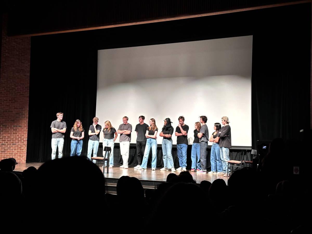 The Tongue ‘N’ Cheek cast stands on stage in Sarratt Cinema before beginning the show’s final game, as photographed Dec. 3, 2024. (Hustler Staff/Corey Lochan) 