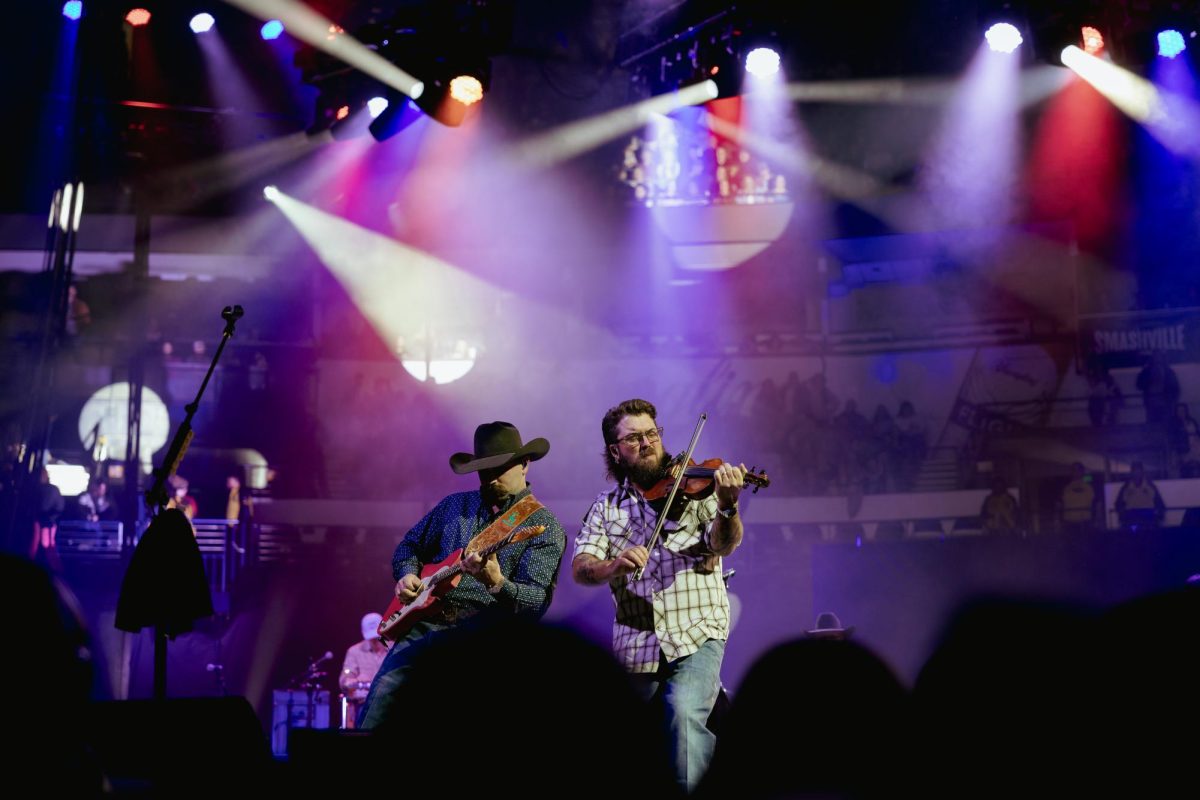 Jake Mears and Jody Bartula, on the guitar and fiddle, perform alongside Cody Johnson, as photographed on Feb. 14, 2025. (Hustler Multimedia/Abbie Bobeck)
