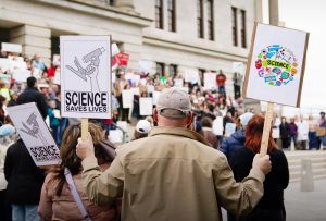 A man holding up two signs at the Stand Up for Science demonstration by the Tennessee State Capitol, as photographed on March 7, 2025. (Hustler Multimedia/George Albu)