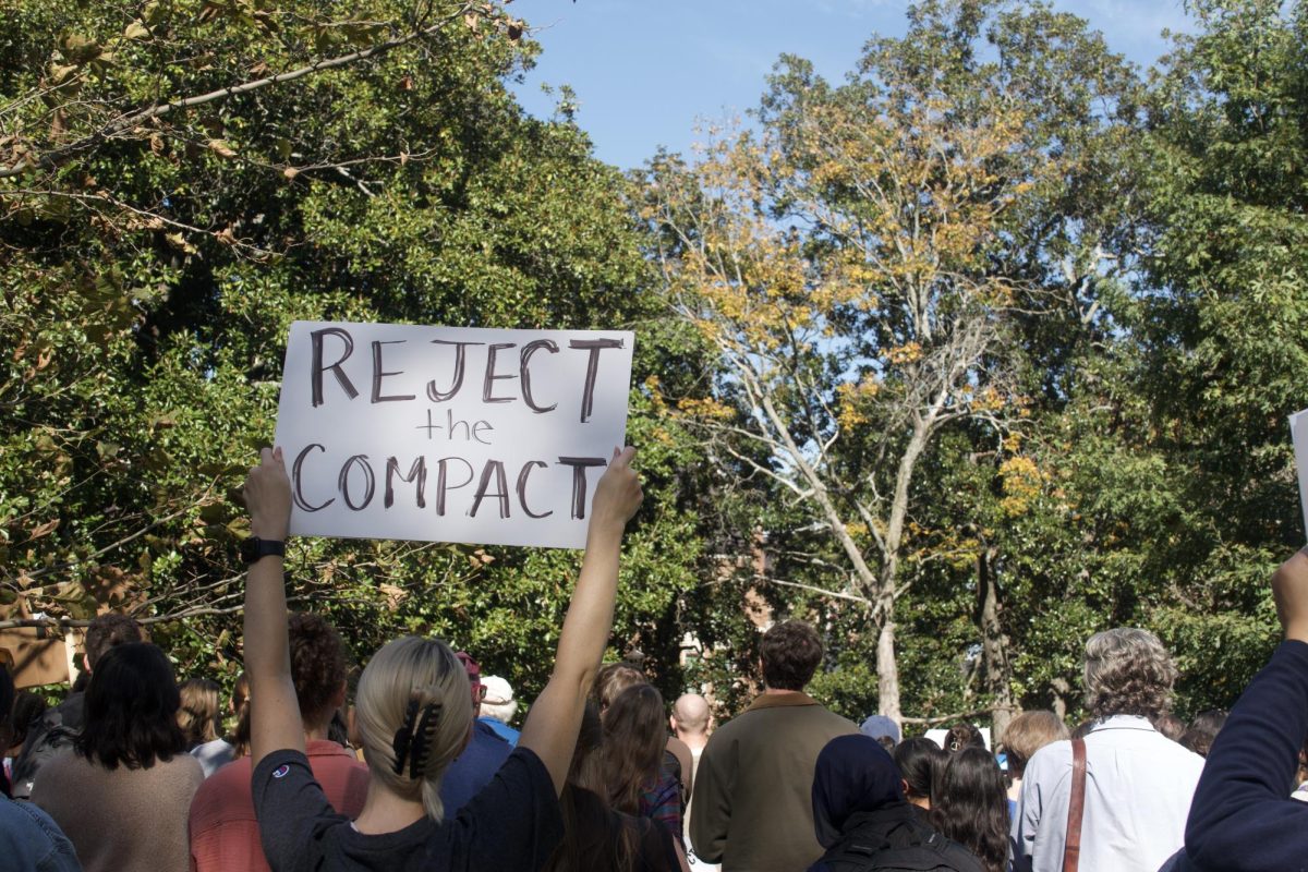 A crowd member holds up a sign reading “Reject the Compact,” as photographed on Nov. 5, 2025. (Hustler Multimedia/Shayna Kar) 