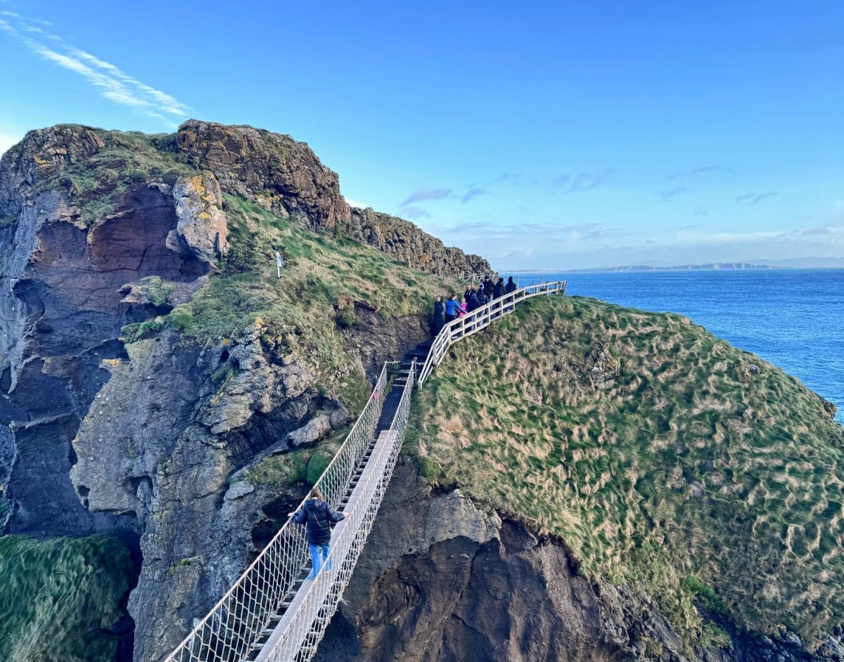 A visitor crosses the Carrick-a-Rede rope bridge in Northern Ireland, as photographed on Nov. 28, 2025. (Hustler Multimedia/Emma Smith) 