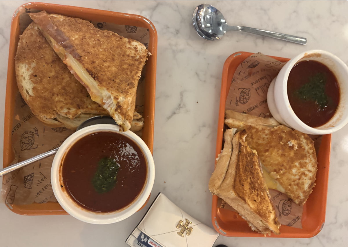Grilled cheese and red pepper and tomato soup are served in trays at Grilled Cheeserie, as photographed on Nov. 12, 2025. (Hustler Multimedia/Riley Croteau)