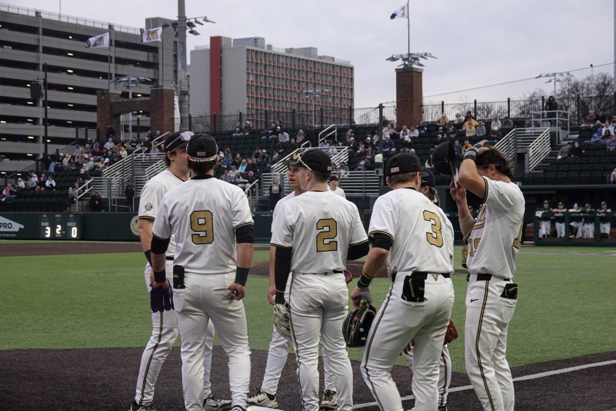 Vanderbilt players huddle up outside their dugout, as photographed on Feb.17, 2026. (Hustler Multimedia/Siena Mahdi)