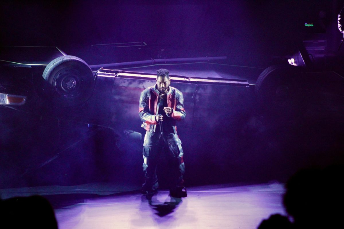 Miguel rolls his shoulders to the rhythm while standing in front of an overturned car that served as his performance platform, as photographed Feb. 11, 2026. (Hustler Multimedia/Paula Legisima)