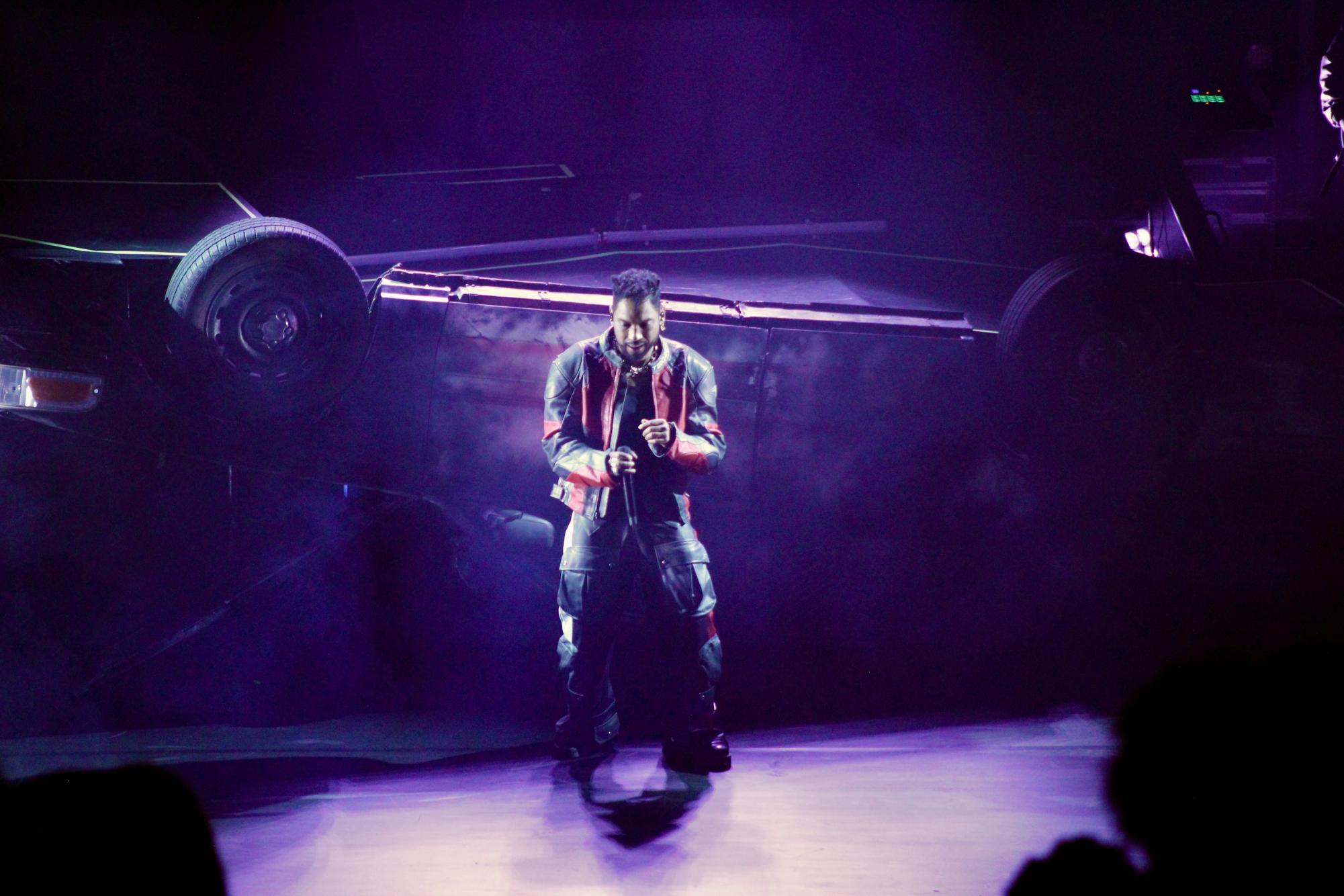 Miguel rolls his shoulders to the rhythm while standing in front of an overturned car that served as his performance platform, as photographed Feb. 11, 2026. (Hustler Multimedia/Paula Legisima)