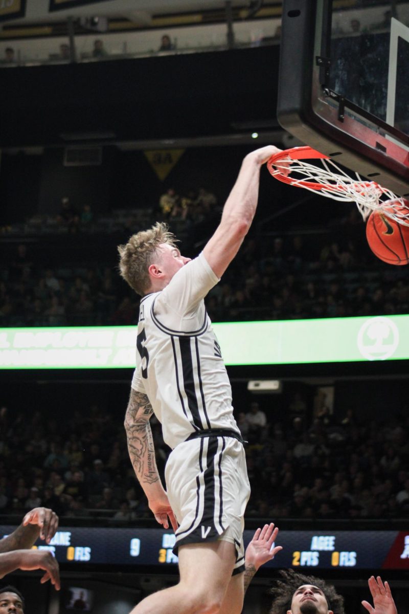 Tyler Nickel dunks the ball into the net, as photographed Feb. 14, 2026. (Hustler Multimedia/Rachel Loomis) 