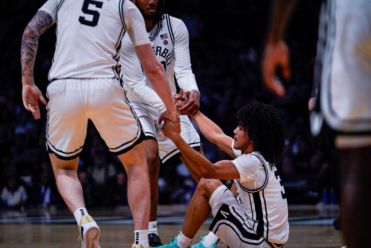 Devin McGlockton and Tyler Nickel help up Tyler Tanner after a play, as photographed on Feb. 21, 2026. (Hustler Multimedia/Michael Tung)