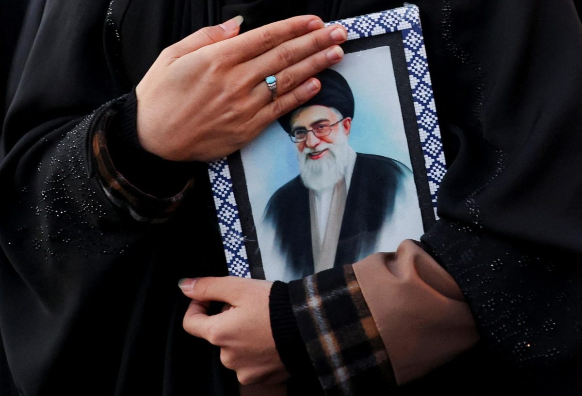 A woman holds on to a picture of Iran's Supreme Leader Ayatollah Ali Khamenei at the Enghelab Square, after he was killed in Israeli and U.S. strikes on Saturday, in Tehran, Iran, March 1, 2026. (Photo Courtesy of Majid Asgaripour/West Asia News Agency via REUTERS)