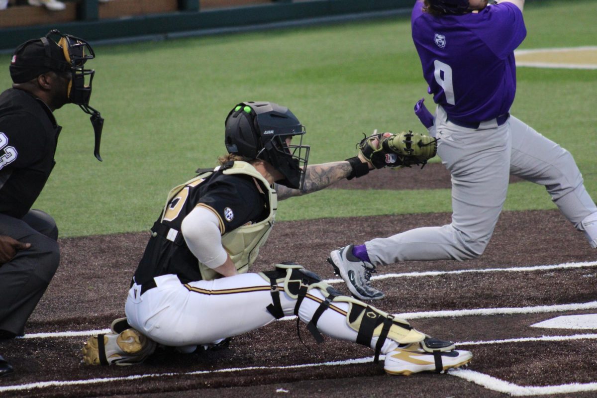Mack Whitcomb squats behind home plate and frames a pitch, as photographed on March 3, 2026. (Hustler Multimedia/ Rachel Loomis)