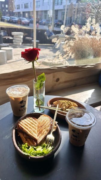 The Babu latte, iced chai, baklava and heart shaped prosciutto and fig sandwich sit on a table, as photographed Feb. 11, 2026. (Hustler Staff/ Daniela Aguilar) 