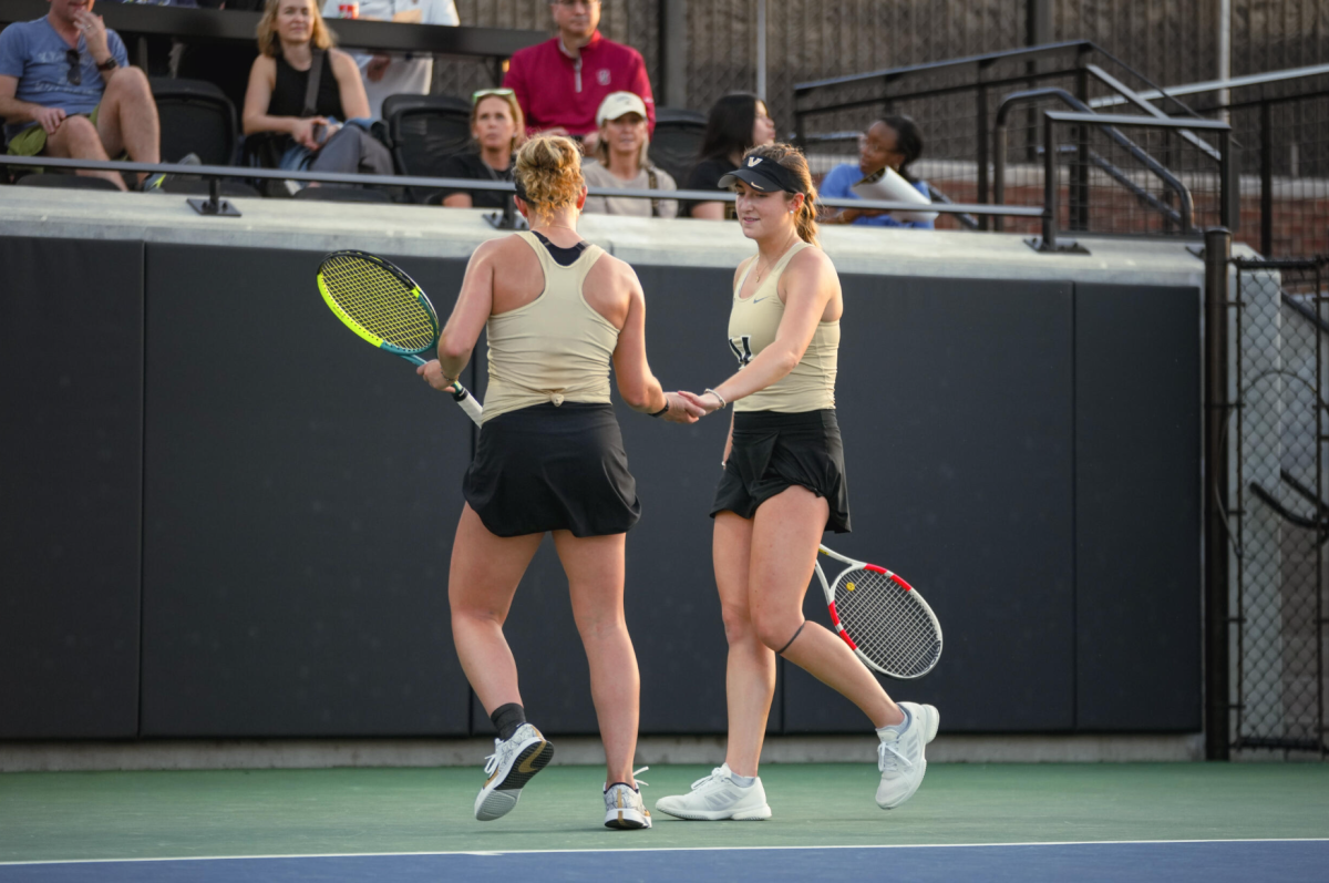 Valeria Ray and Bridget Stammel hugh five after a point, as photographed March 6, 2026. (Vanderbilt Athletics)