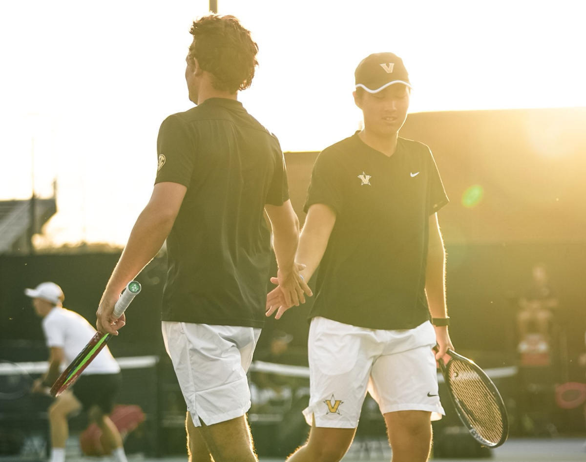 Two Vanderbilt Men’s Tennis players high five each other, as photographed on March 22, 2026. (Vanderbilt Athletics)