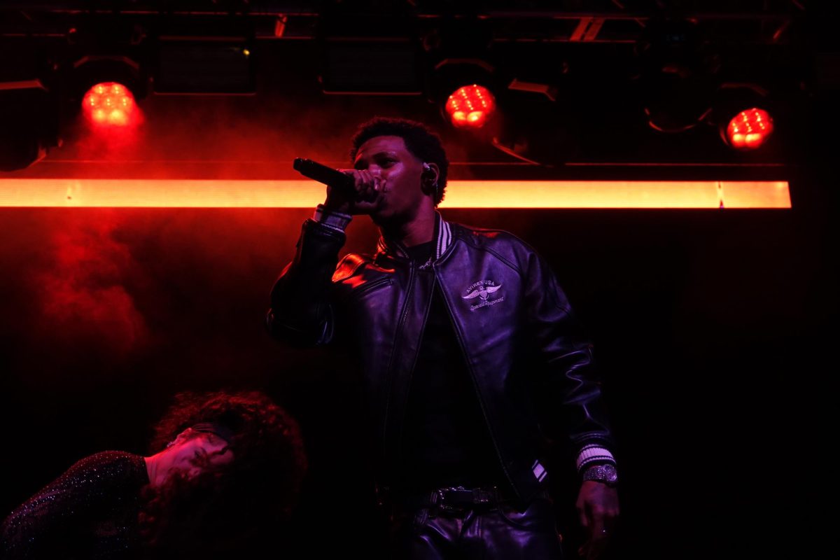 A Boogie Wit Da Hoodie sings into the microphone under red lights at Rites of Spring, as photographed April 18, 2026. (Hustler Multimedia/Adriana Tan) 