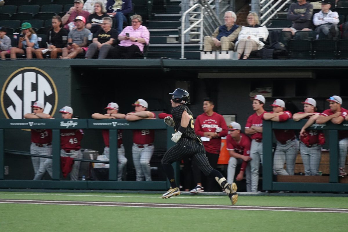 Vanderbilt Baseball player runs past Oklahoma Sooners players at the bench, as photographed April 9, 2026. (Hustler Multimedia/Meagan To)