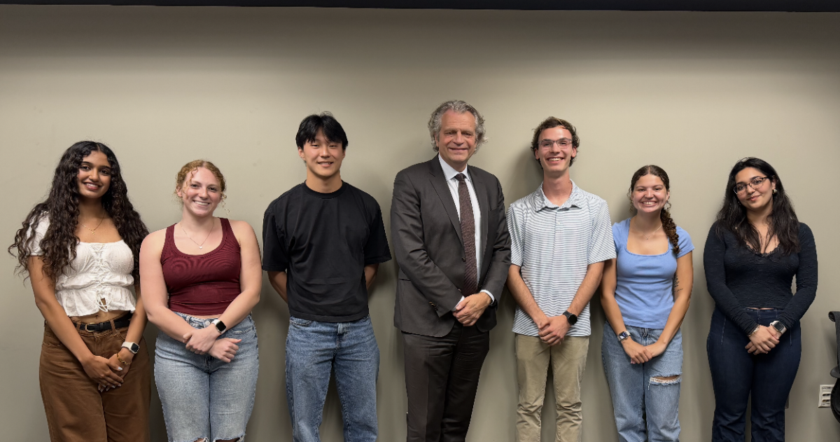 From left to right, Swarada Kulkarni, Hailey Weiner, Vincent Xu, Chancellor Daniel Diermeier, Jacob Stoebner, TaMyra Johnson, Shayda Oliaei, as photographed April 17, 2026. (Hustler Multimedia).
