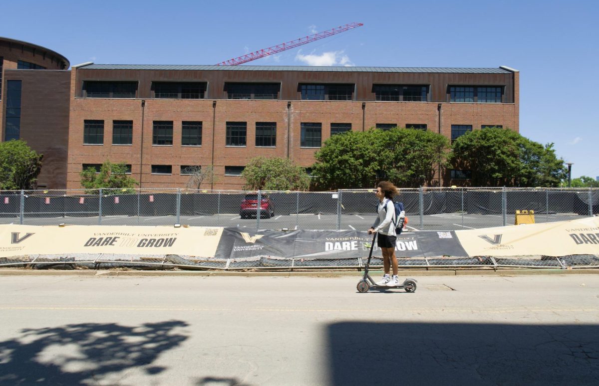 A student rides their scooter by the Student Life Center construction site on a sunny morning, as photographed April 19, 2026. (Hustler Multimedia/George Albu)