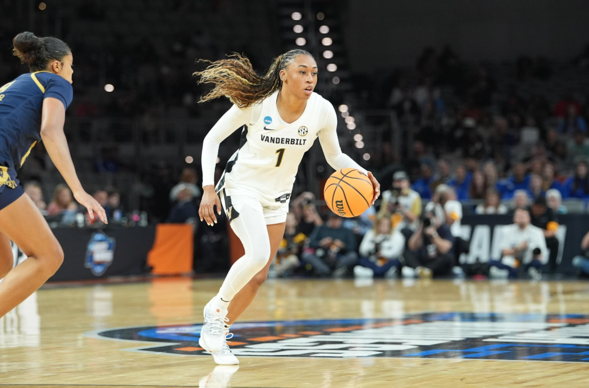 Mikayla Blakes dribbles the ball in her left hand with her eyes up while a Notre Dame player defends her, as photographed March 27, 2026. (Photo Courtesy of Vanderbilt Athletics)
