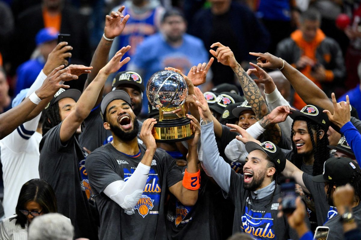 May 25, 2026; Cleveland, Ohio, USA; New York Knicks center Karl-Anthony Towns (32) lifts the 2026 Eastern Conference trophy with teammates after defeating the Cleveland Cavaliers in game four of the eastern conference finals for the 2026 NBA playoffs at Rocket Arena. Mandatory Credit: David Richard-Imagn Images